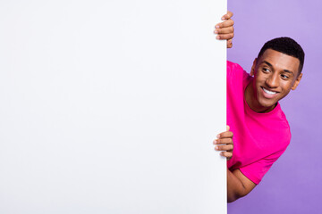 Photo of cheerful man wear stylish pink clothes hand hold empty space interested look news...