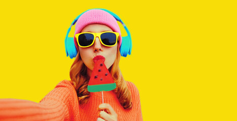 Summer fresh colorful portrait of young woman taking selfie in headphones listening to music with...