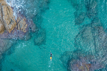Aerial top view from drone of a swimmer in open water with wetsuit and buoy - obrazy, fototapety, plakaty