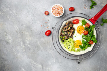 egg, avocado, mushrooms in a pan, Delicious breakfast or snack, Clean eating, dieting, vegan food concept. top view