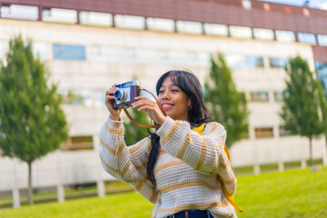 Asian young woman photography with a vintage photo camera, enjoying photography