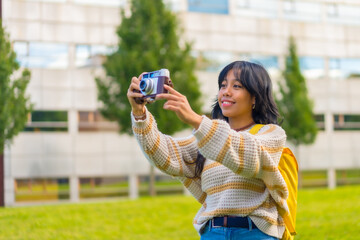 Asian young woman photography with a vintage photo camera, backpacking traveler concept
