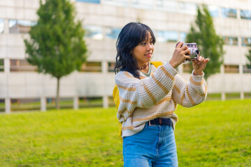 Asian young woman photography with a vintage photo camera, backpacking traveler concept