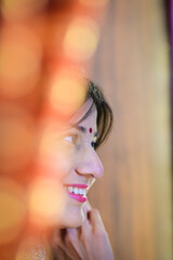 Beautiful indian bride. Face Profile. Watching in mirror.  Elegance silk shine of veil. Silk cape. Romantic indian woman. Colorful. Getting Ready 