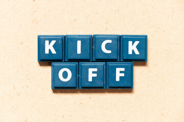 Tile letter in english word kick off on wood background - obrazy, fototapety, plakaty