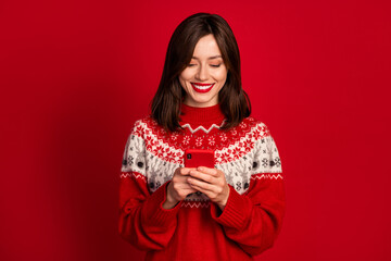 Photo of positive cheerful optimistic girl straight hairstyle wear red sweater typing message in...