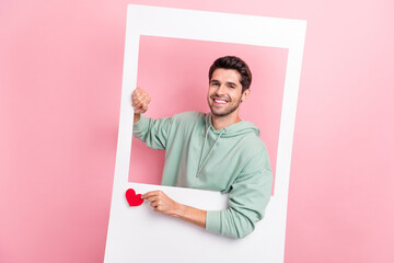 Portrait of positive person hands hold paper window card little heart like isolated on pink color...