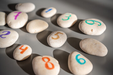 Colorful stones signed by numbers, an alternative method of children education. Number 5 in center