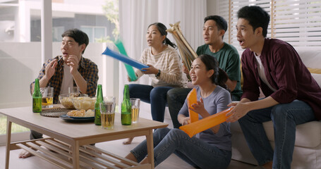 Group of young adult friend man and woman asia people sit at sofa couch joy chanting party fun game...