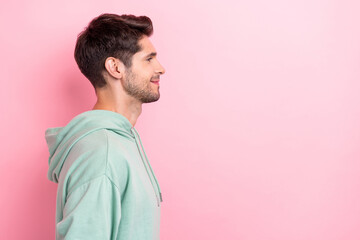 Profile photo of positive cheerful dreamy man looking empty space after barber nice hairstyle looking empty space interested isolated on pink color background