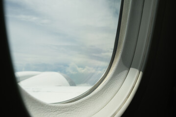 The aeroplane window with the cloud scene.