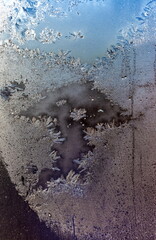 Frosty drawing on the window close-up in winter
