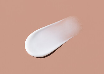 cosmetic smears cream texture on pastel brown background