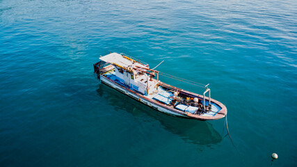 Fishing boat anchored behind coral reef