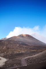 Mount Etna, Sicily, Italy. Slopes with traces of solidified lava. Crater of Mount Etna. Smoking...