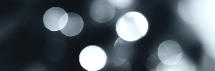 Blurred lights, gray, deep blue background, banner texture. Abstract bokeh with soft light header. Wide screen wallpaper. Panoramic web banner with copy space for design