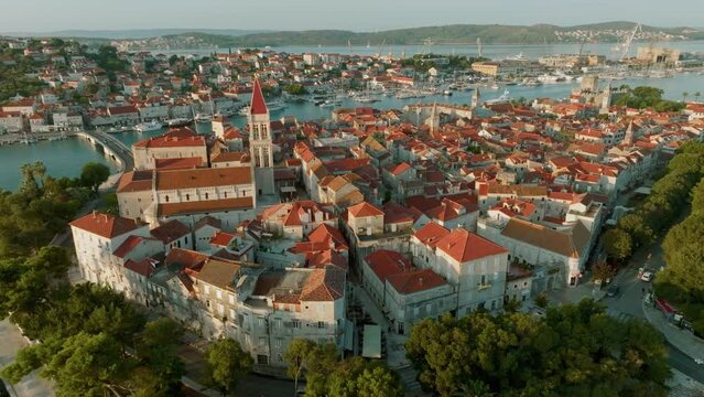 Aerial shot of magnificent Venetian city on the Adriatic Sea - Trogir, Croatia. Morning shot of old town Trogir with orange tiled roofs