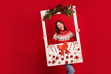 Photo of cheerful attractive person hands hold paper decorated album card isolated on red color background