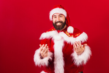 brazilian santa claus young caucasian man. calling with the hands, inviting with the hands.