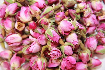Obraz na płótnie Canvas tea made from dried natural pink rose buds, close-up as a background