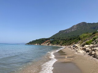 Fototapeta na wymiar Rocky Prasoudi beach in Corfu island, Greece, in summer time