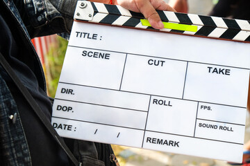 close up image of film production crew holding Film Slate on set