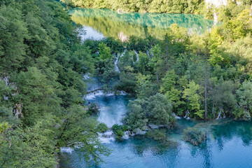 Majestic view of waterfall with crystal clear water in forest in The Plitvice Lakes National Park...