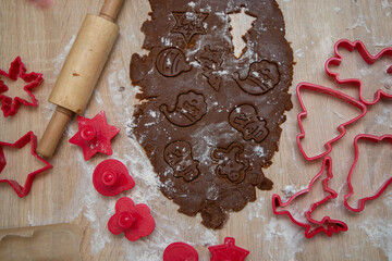 Gingerbread dough for Christmas cookies and cookie cutters.