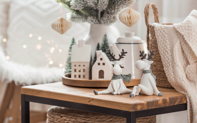 A bouquet of Christmas trees, reindeer, a blanket in a basket and Scandinavian white houses on a...
