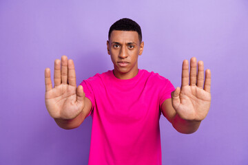 Photo of young serious strict young guy student showing stop gesture dont like drink alcohol party...