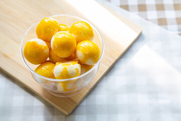A cup of Sweet Filling with Salted Egg on a wooden cutting board ready for eat.