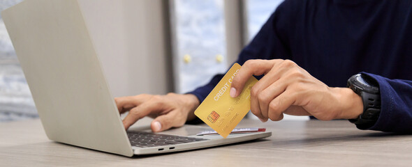 Businessman holding credit card for online shopping bill on smartphone, positive man shopping online remote payment , smart payment concept individual bank