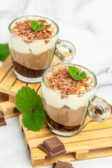 dessert three chocolates with mint on a light background. Layered delicious dessert. vertical image. place for text