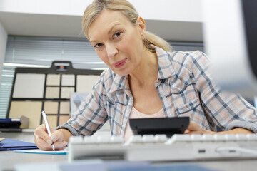 mature woman trying to reconcile her bills