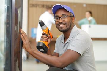 male handyman using cordless drill