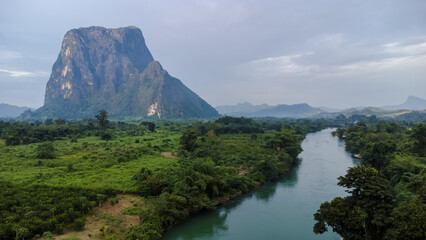 Naklejka na ściany i meble Aerial view river and mountain at countryside in Laos from drone