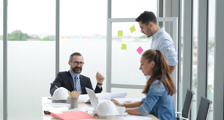 Construction engineer and architect check plan working with the blueprint on office worker conference site. Engineers team meeting for architectural project. Construction Concept.