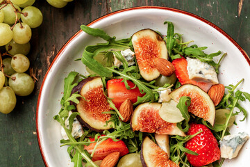 salad with figs, strawberries, grapes, blue cheese dorblu. superfood concept. Healthy, clean eating. Vegan or gluten free diet