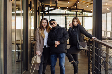 Three young models are walking around the city