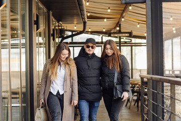 Three young models are walking around the city