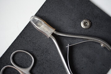 iron tools for a home beauty salon on the background of a leather black tool case, pedicure...