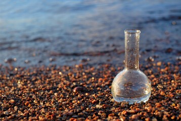 Water sample on seaside background for analiysis. Ecology concept, with copy space