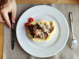 A plate of delicious potatoes and baked meat. top view of the serving