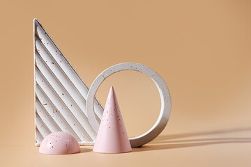 Geometric concrete figure and stones on pastel background. Modern set from various materials and geometric shapes.