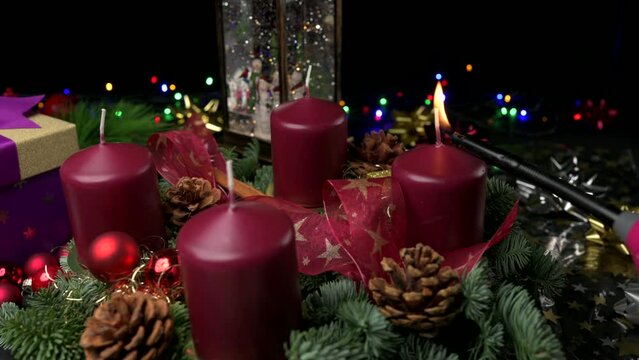 Advent wreath one candle being lit amongst christmas decor with space for copy