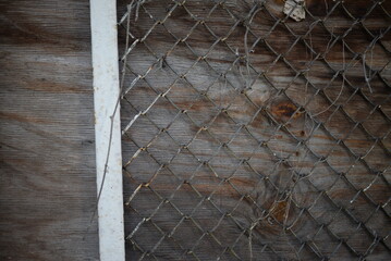 background iron square pattern on wooden gray old fence, mesh and wood texture background, gradient...