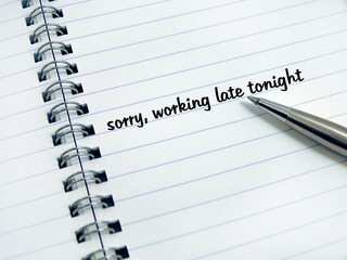 pen and diary with phrase: working late tonight