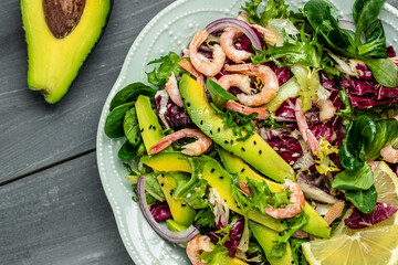 Seafood salad with shrimps, avocado slices and fresh greens, Healthy food. superfood concept. clean eating concept. Vegan or gluten free diet. top view