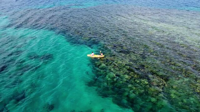 Canoeing over Coral Reef in Papua New Guinea