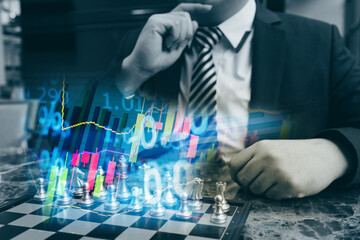 Double exposure of young business man and digital number of stock market background to represent...